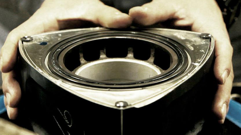 A vintage photo of a triangular Mazda rotor.